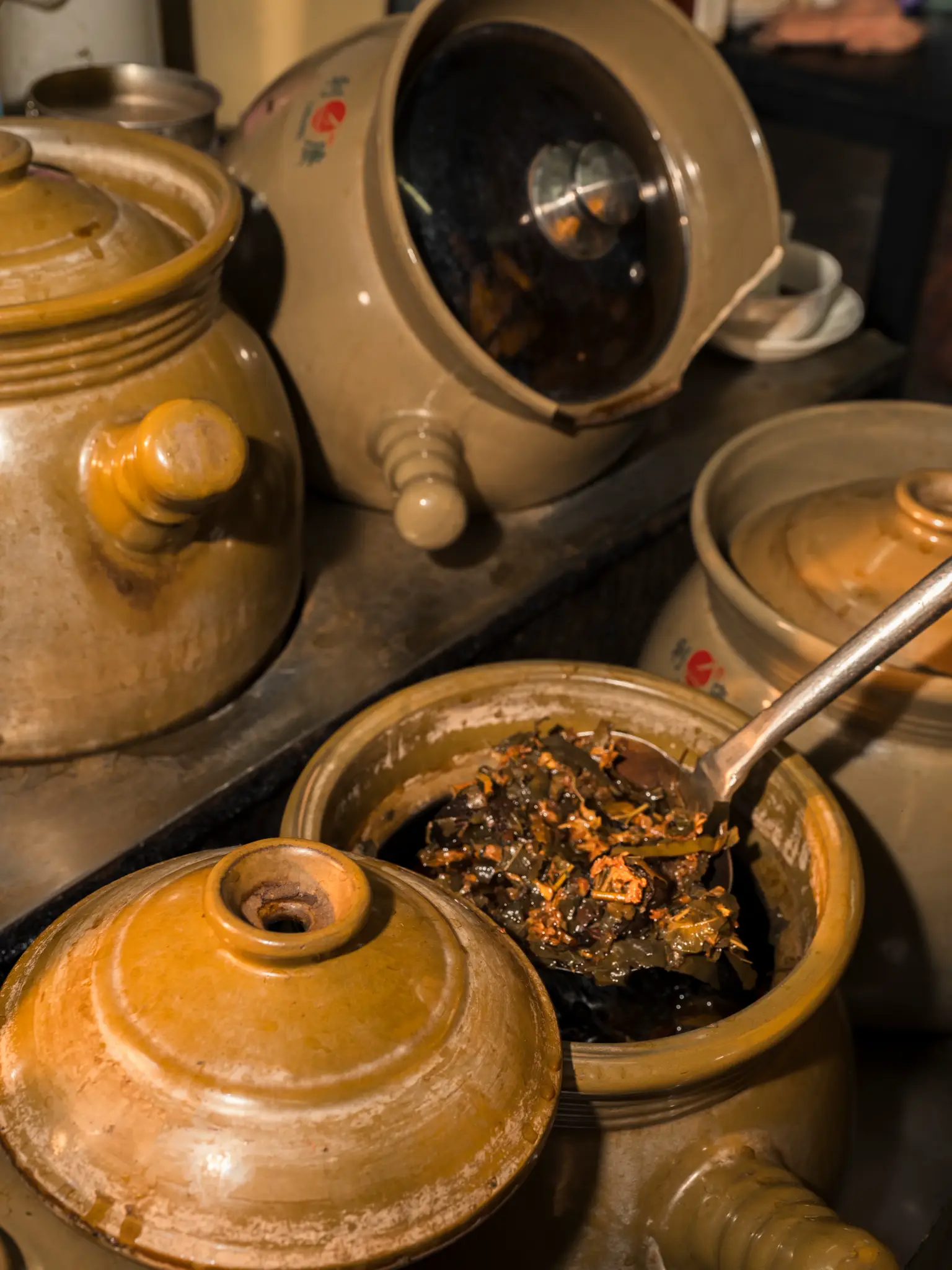 Glazed clay pots holding preserved ingredients