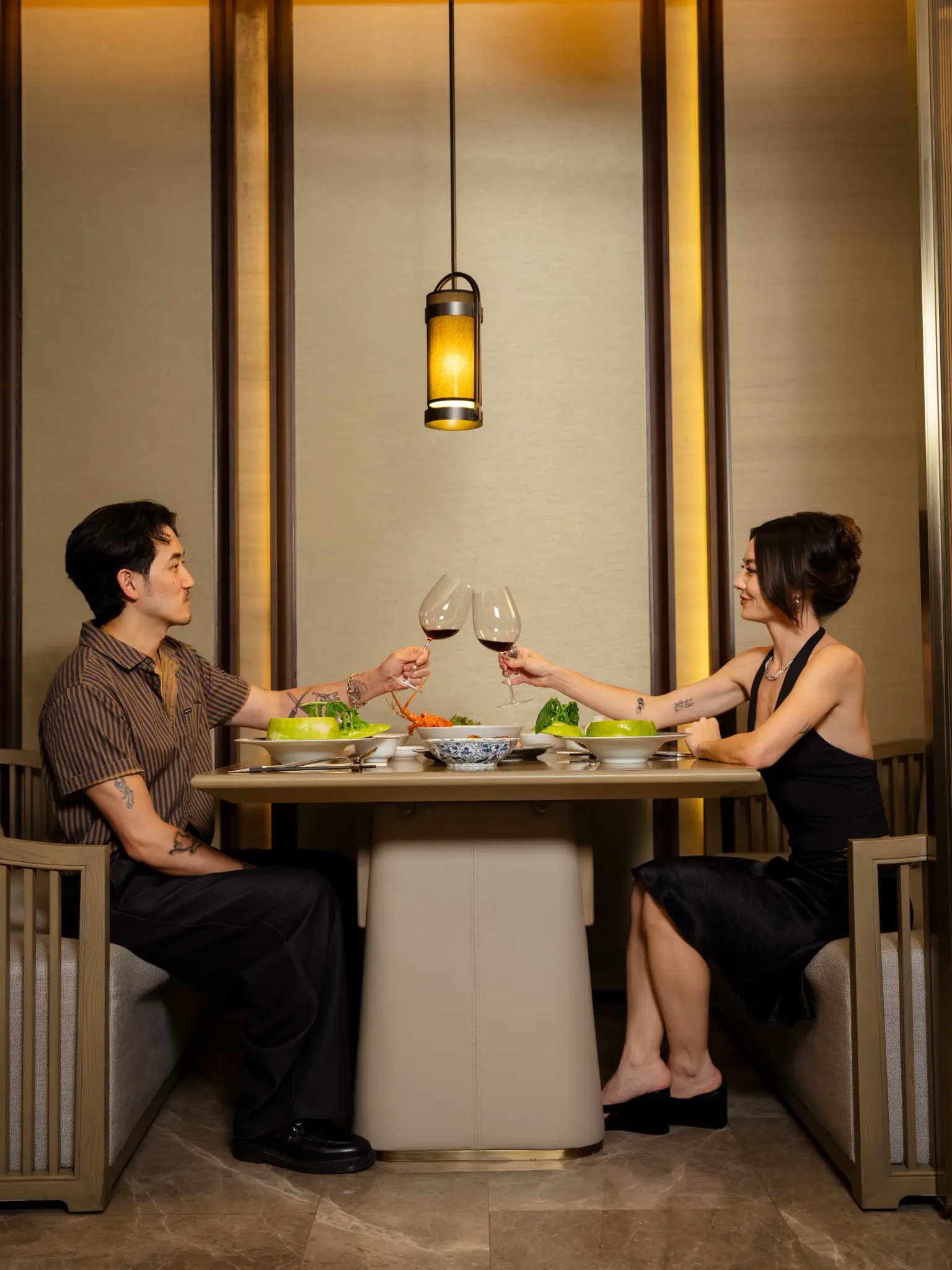 Ewa and Jeromy Ko toasting over dinner at ManHo Nanshan
