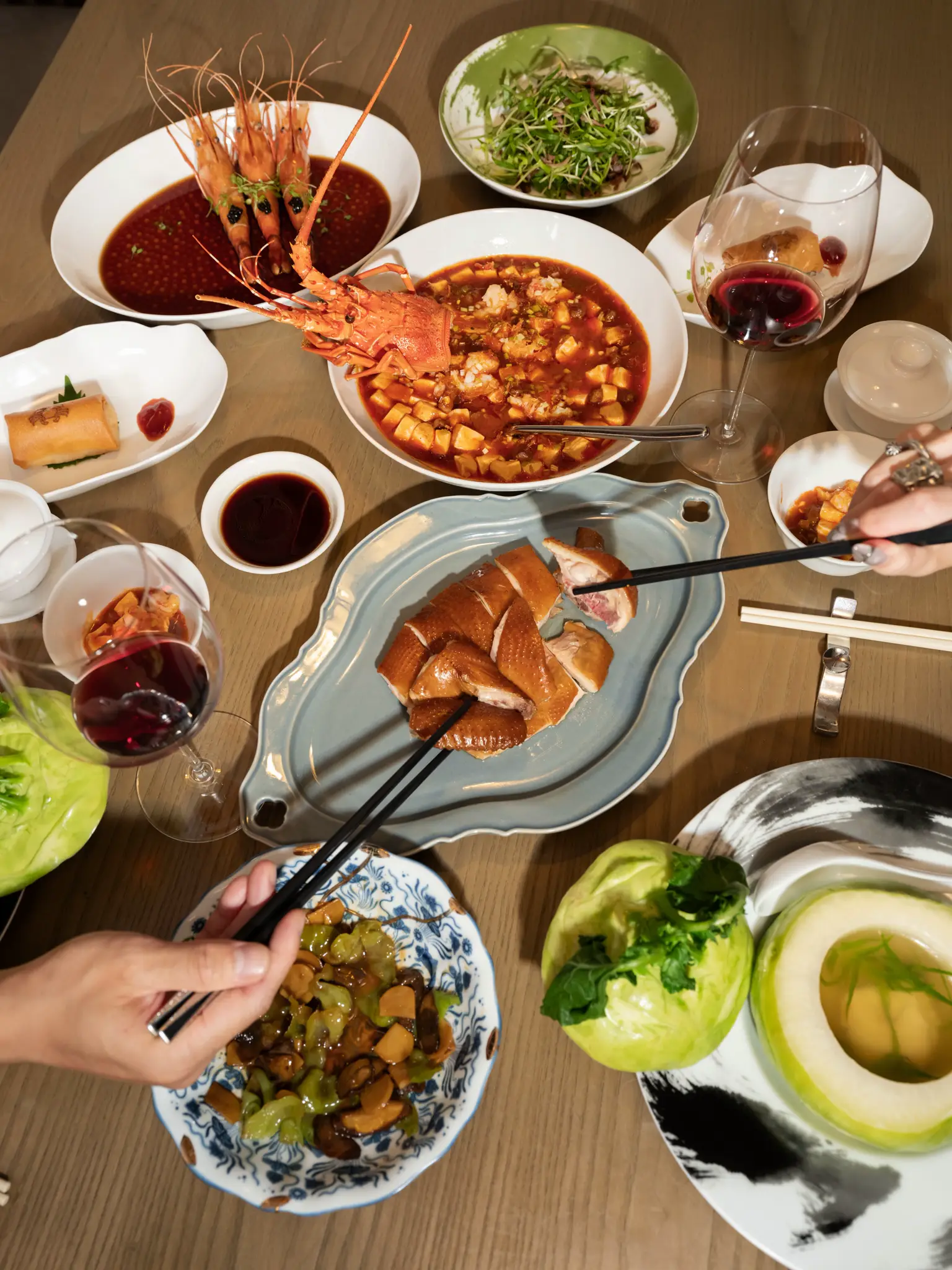 Overhead view of Cantonese dishes shared across a dining table